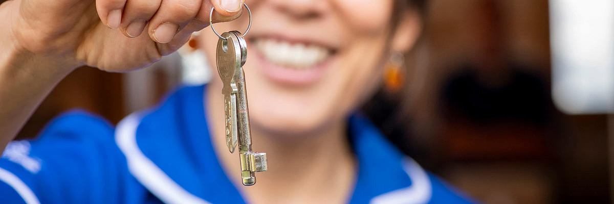 A member of the Client Services Team handing over the keys